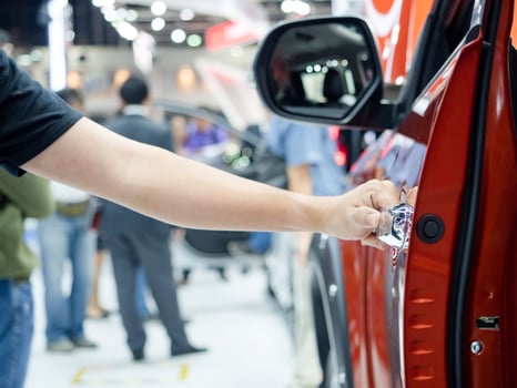 Hand opening the door car with event motor show concept background photo