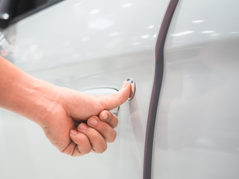 Closeup hand scan door car white color and blur event motor show concept photo