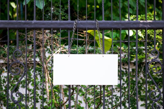 Empty sign over a metallic fence photo