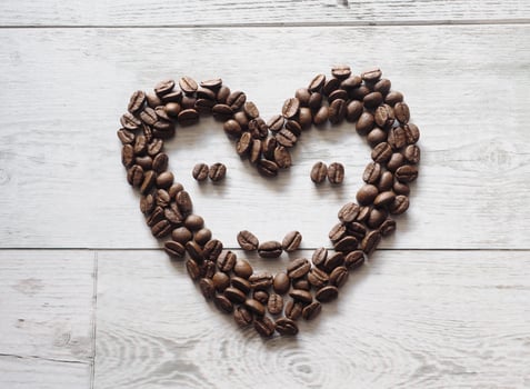 Coffee seed face smile happy on wood background top view idea coffee concept copy space photo