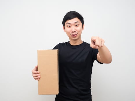 Man holding parcel box and point finger at you photo