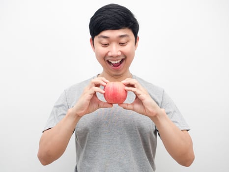 Man grey shirt gesture eatting red apply portrait white background photo