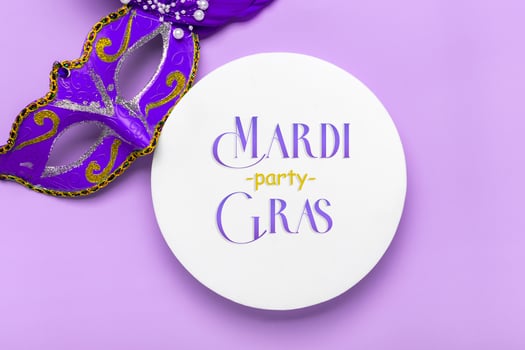 Mardi gras lettering. Congratulation card with mask on white podium on violet background Top view 2022 Mardi Gras Parade Schedule photo