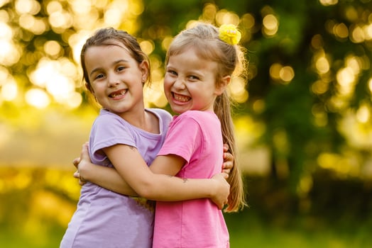 Two happy little sisters on the field. photo