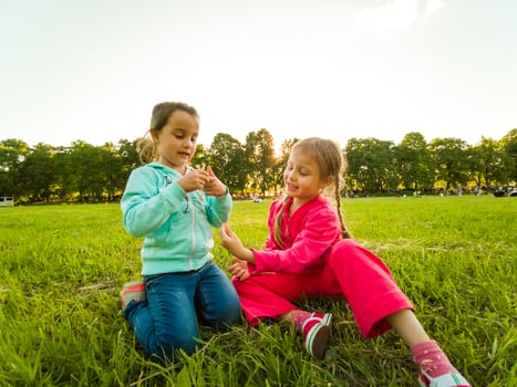 two little girls walking in the field. photo