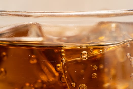 Close up Cola with Ice and bubbles in glass. Ice cubes in cola beverage. photo