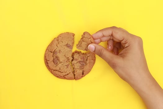 overhead view of breaking sweet cookies on yellow background photo