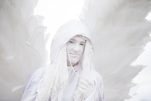 A man in a white angel costume with wings close-up.Gothic white angel. photo