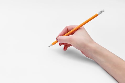 Female hand holding pencil isolated on white background, close-up, cutout, copy space photo