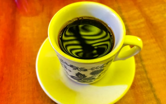 Blue white cup pot with black coffee wooden table Mexico. photo