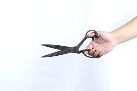 hand holding scissors isolated on white background photo