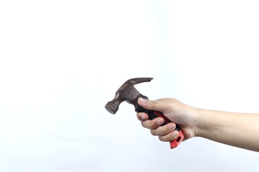 hand holding hammer isolated on white background photo