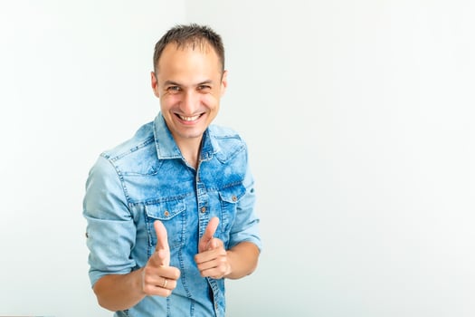 Handsome young man smiling with arms crossed on white background photo