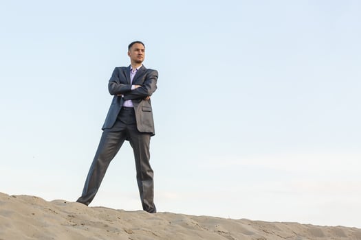 Handsome man elegantly dressed walking the desert photo