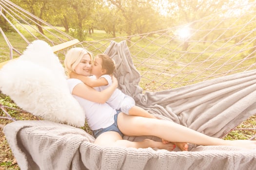 happy mother with her daughter lying in a hammock photo
