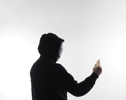 Credit cards personal data stolen by anonymous man in Black hood shirt. photo