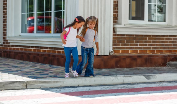 Two schoolgirls go to school. The concept of school, study, education, friendship, childhood. photo