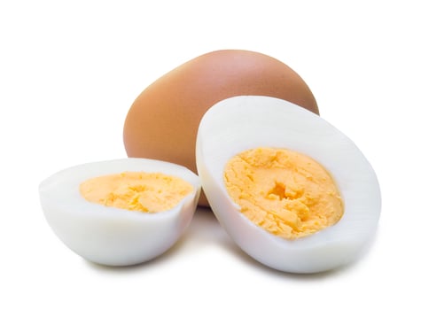 Close up of boiled chicken eggs with peeled halves isolated on white background with clipping path, Selective focus photo