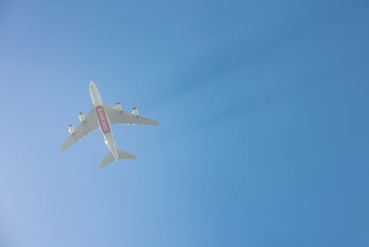 Airplane flying in mid-air with clear blue sky in the background photo