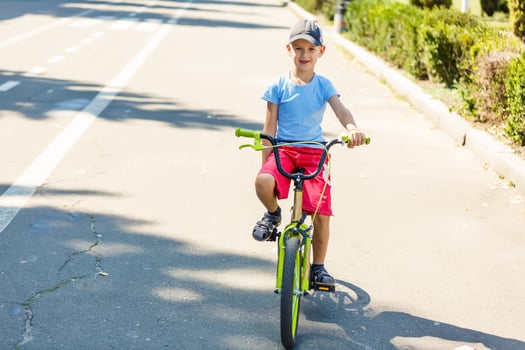 Little boy being really fast on his bicycle photo