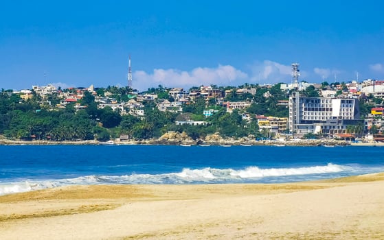 Sun beach people waves and boats in Puerto Escondido Mexico. photo