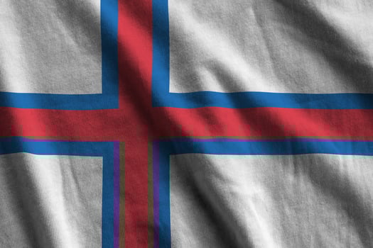 Faroe islands flag with big folds waving close up under the studio light indoors. The official symbols and colors in banner photo