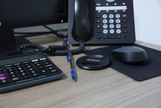 office desk stuff with phone mouse and keyboard photo