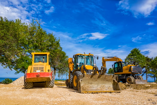 day view of stopped industry vehicles at the construction site photo