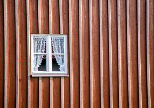 beauty wooden window with curtains in a house facade wall. photo
