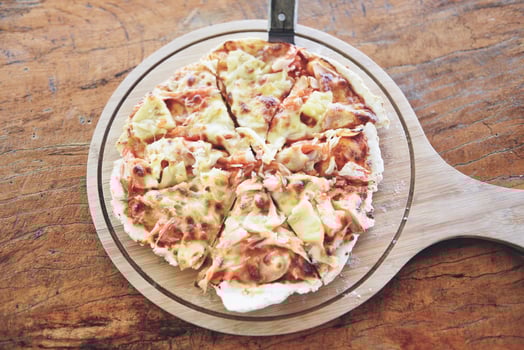 Pizza cheese slice on wooden tray and served on a wooden table , top view Homemade pastry pizza Italian is cooked traditional food photo
