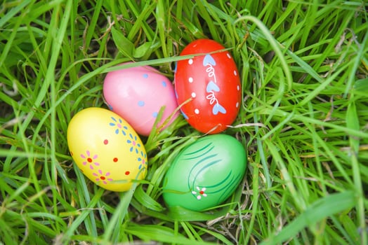 Easter eggs hunt on green grass meadow outdoor photo