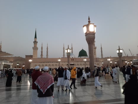 Medina, Saudi Arabia, Dec 2022 - Beautiful evening view in Masjid al-Nabawi, Visitors are seen in the lights of the mosque in the premises of the mosque. photo