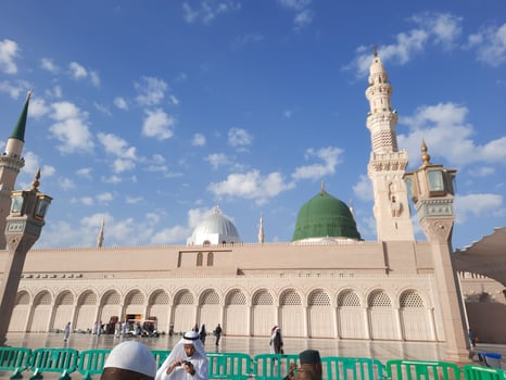 Beautiful daytime view of Masjid Al Nabawi, Medina's green dome, minarets and mosque courtyard. photo