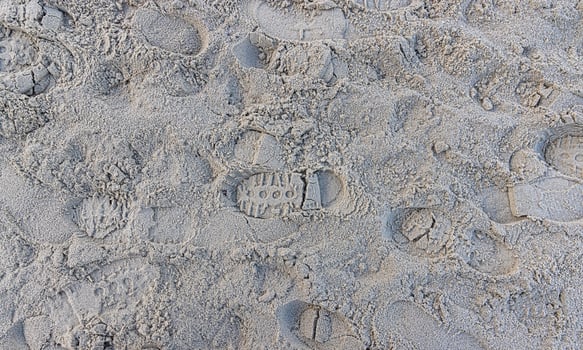 Image of footprints in the sand of a beach photo