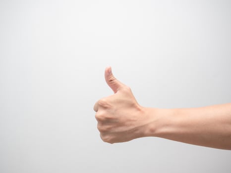 Close up man hand make thumb up white isolated photo