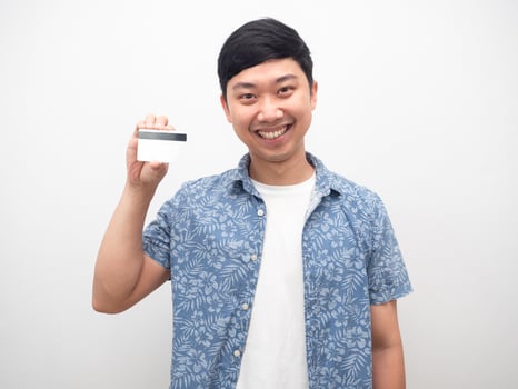 Portrait man blue shirt smiling happy showing credit card photo