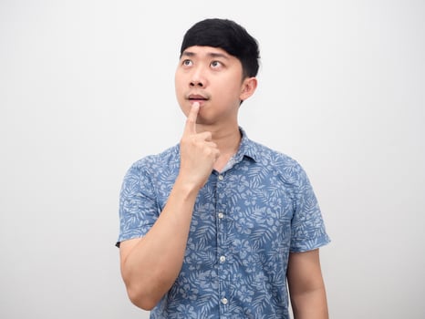 Portrait asian man gesture touch his mouth thinking about choosing photo