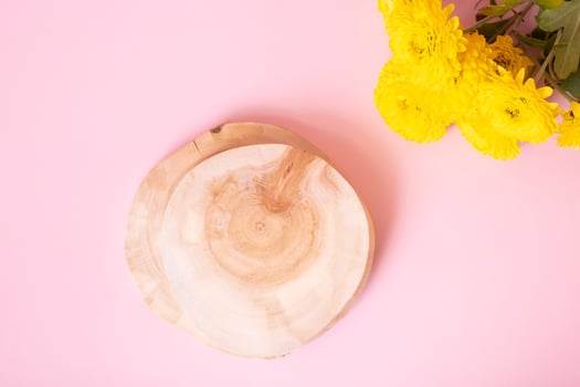 Wooden podium or pedestal with chrysanthemum flowers top view. Mockup for your cosmetic products photo