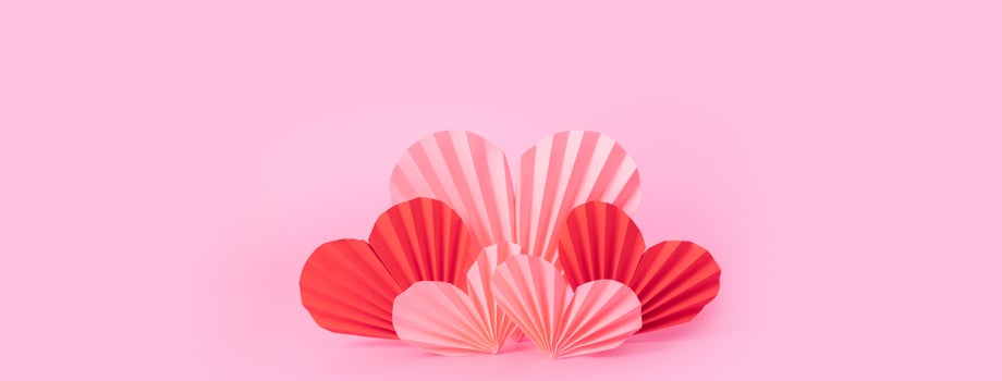 Banner with paper hearts on pink background. Still life  minimalistic composition for Vlentines Day photo