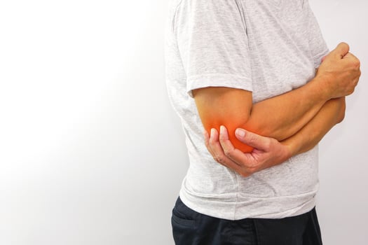 Woman suffering from elbow pain on white background. Healthcare and office syndrome concept. photo