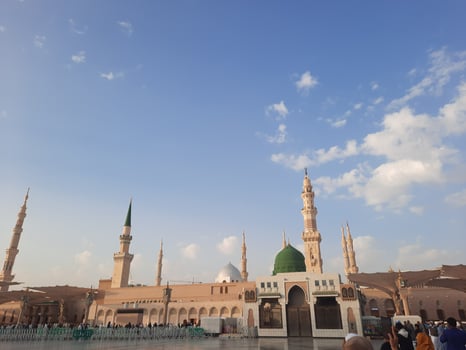 Beautiful daytime view of Masjid Al Nabawi, Medina's green dome, minarets and mosque courtyard. photo