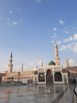 Beautiful daytime view of Masjid Al Nabawi, Medina's green dome, minarets and mosque courtyard. photo