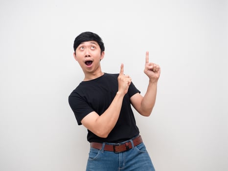 Young man black shirt feels amazed point finger above isolated photo