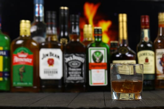 KYIV, UKRAINE - MAY 4, 2022 Many new bottles of worldwide popular alcohol brands of whiskey cognac photo