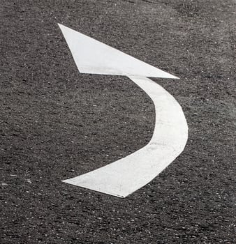 White arrow on asphalt road, traffic sign photo