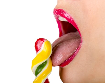 Sexy woman with red lips holding lollipop photo