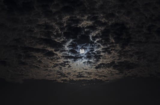 Close up picture of the shiny full moon with cirrostratus clouds photo