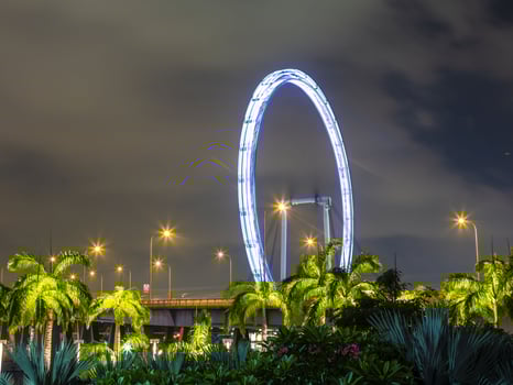 Night scene from Singapore Marina Bay district with Singapore flyer in September photo