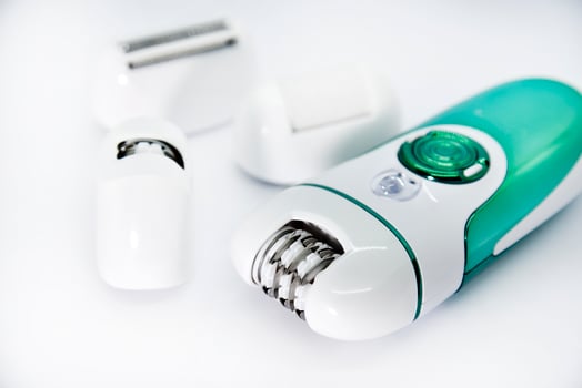 Women's electric razor for intimate places. A set of women's razor for hair on a white background. A white electric razor. photo