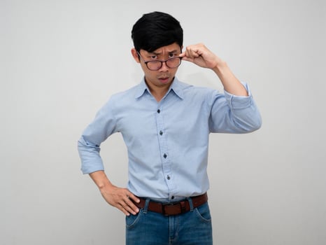 Asian businessman feels confused and excited gesture take off his glasses to looking isolated photo